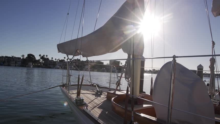A sailboat anchored on rippling water