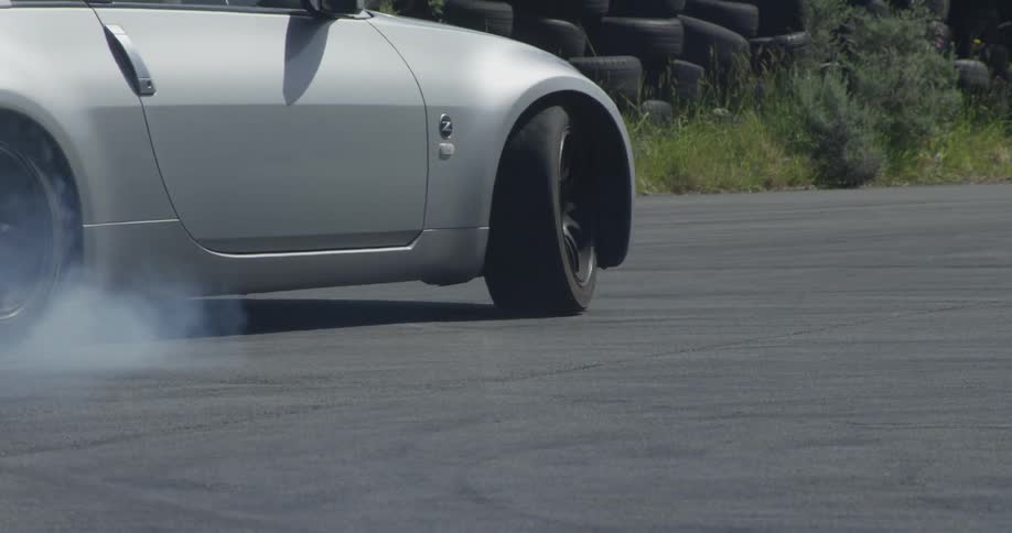 A car drifts and burns rubber on a road
