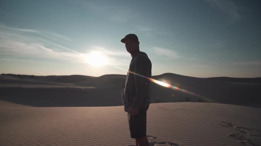 Man standing in the desert on a sunny day