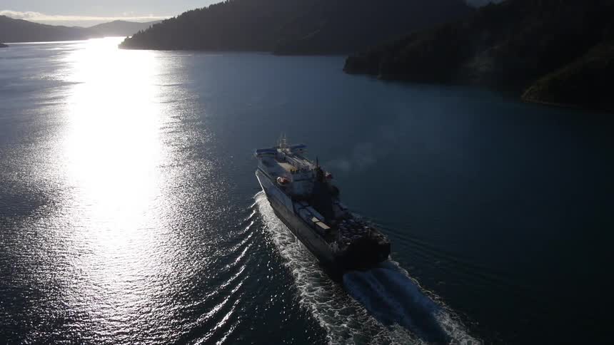 A boat travelling over water between cliffs