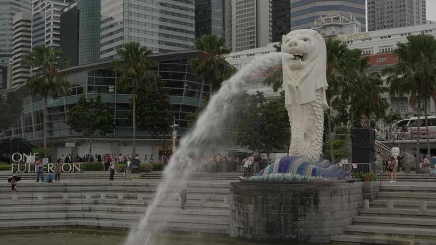 Water spouts from the mouth of an outdoor water fountain