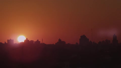 The sun is setting over a cityscape