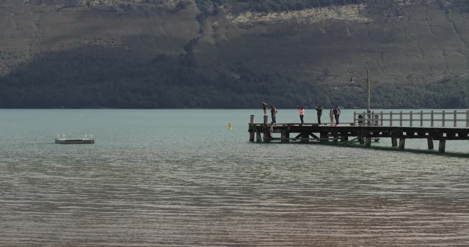 A scenery of people playing in the lake