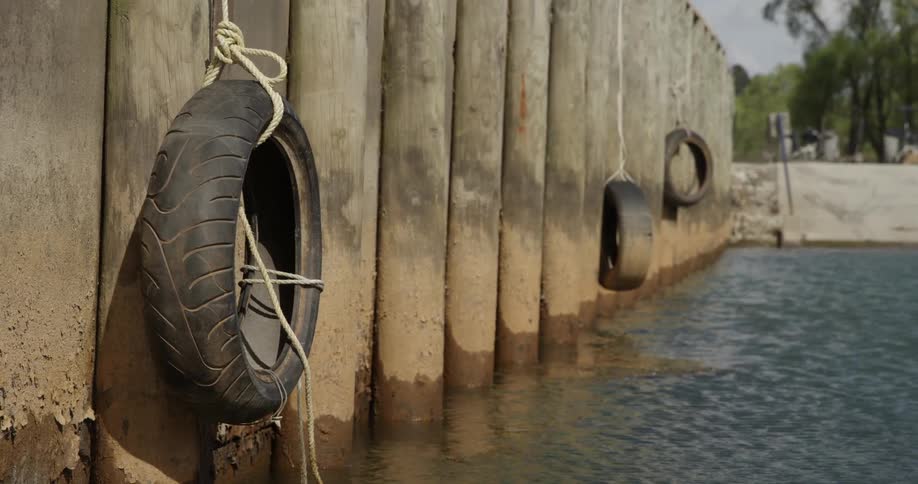 Tires hanging off of a dock