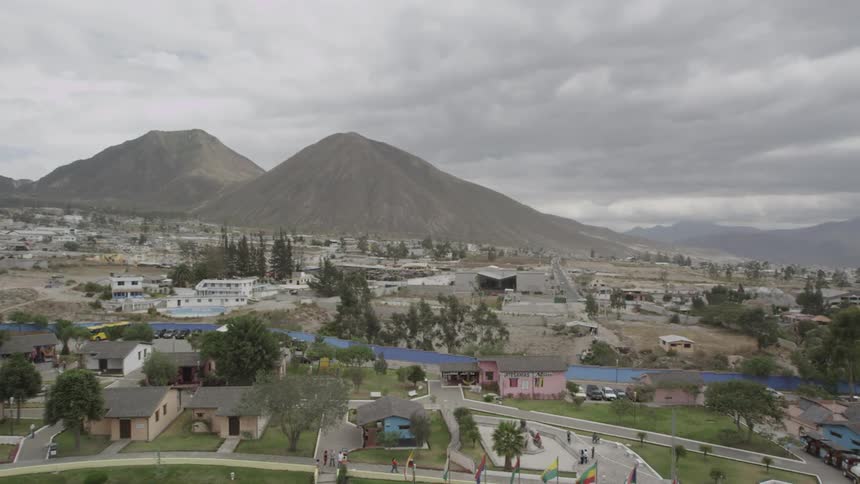A town near mountains is shown from above