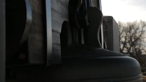 A large bell rocks gently back and forth