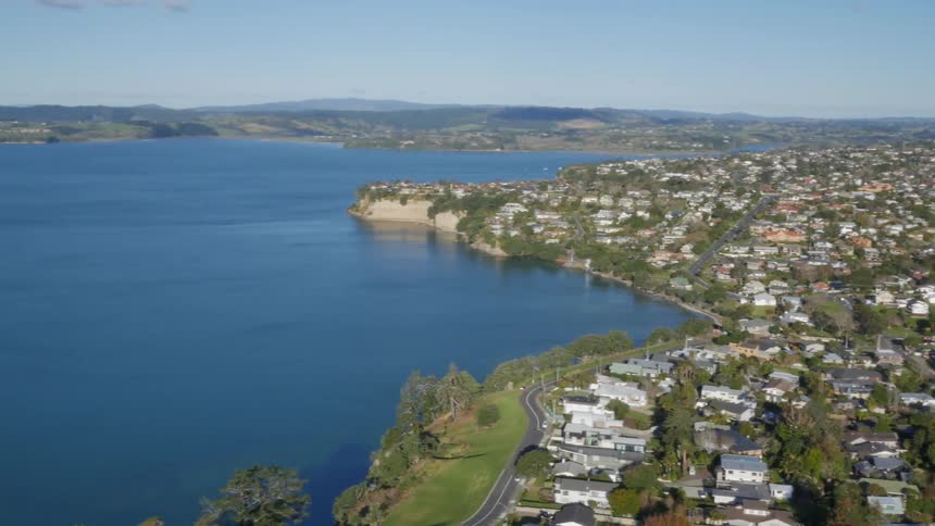 A city sits beside a large body of water