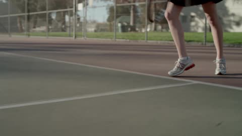 A tennis player serves and then runs to the net
