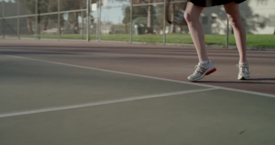 A tennis player serves and then runs to the net