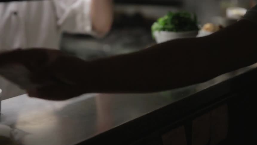 A chef prepares orders in a restaurant