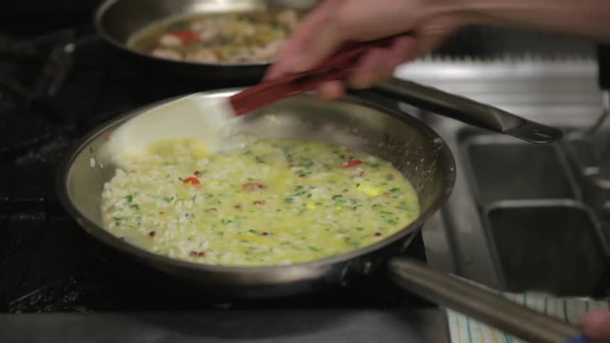 A person stirring food in a pan