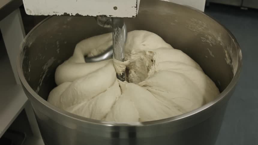 An industrial-sized blender mixing dough