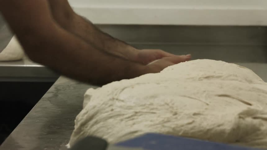 A person rolling dough