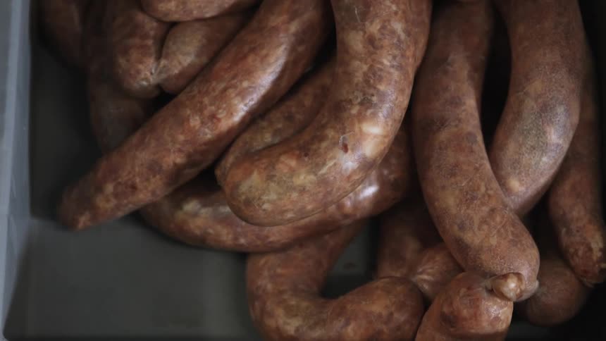 Sausages lay bunched in a pile