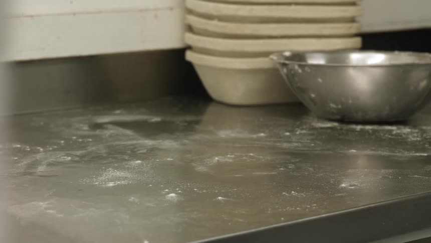 A person kneeding dough