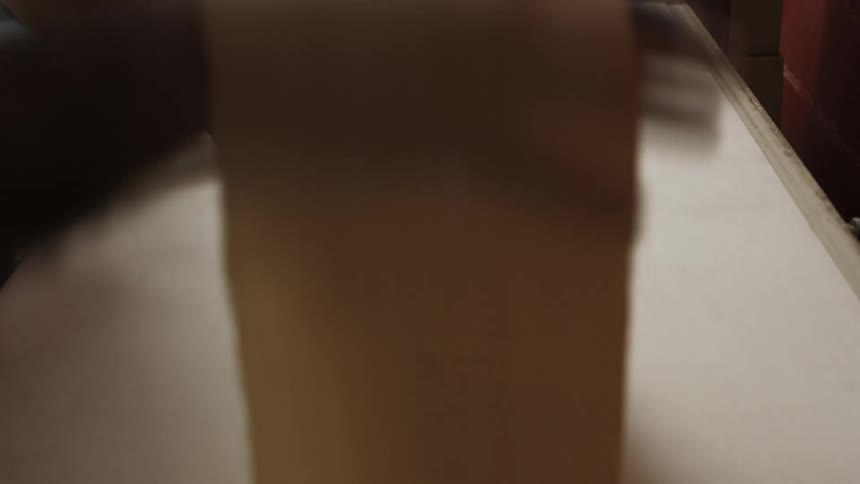 Long strips of dough rolling out of a machine