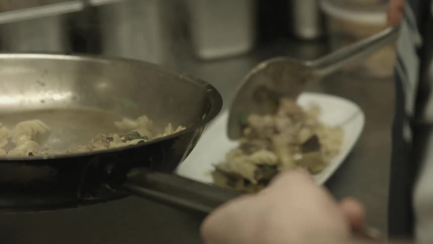 Food being dished onto plates