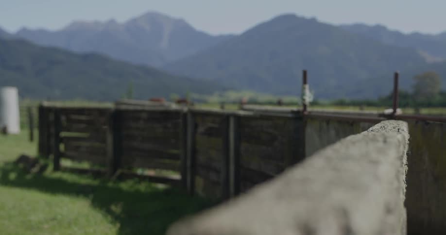 A wood fence sits before a mountain range