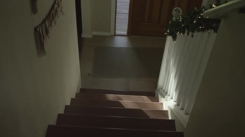 Slowly descending a staircase in a residential home