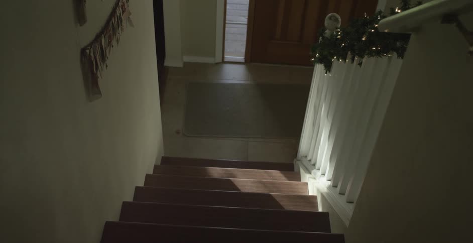 Slowly descending a staircase in a residential home