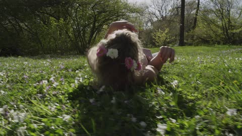 A girl rolling in the grass