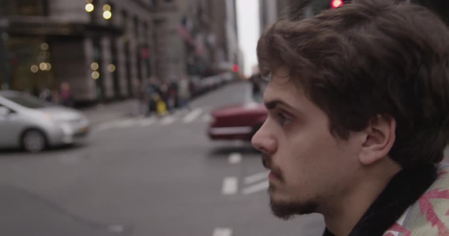 A man crosses a busy city street