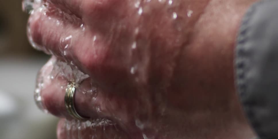 Water running over a person's hands