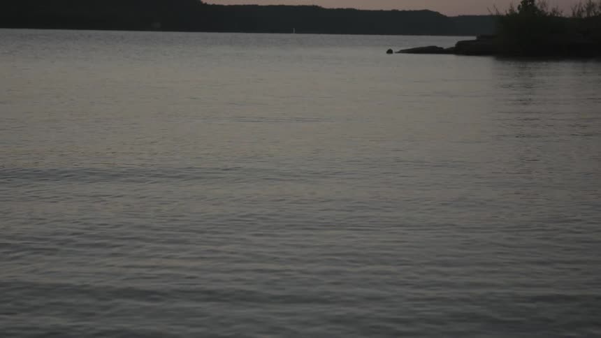 A stone is skipped across a rippling lake