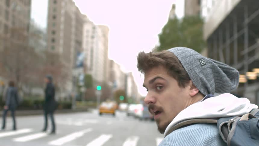 A portrait of a young man in the middle of city