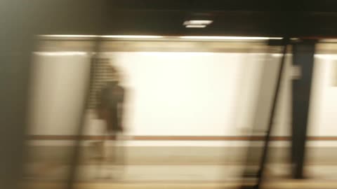 View from inside of a commuter train as it speeds through a station