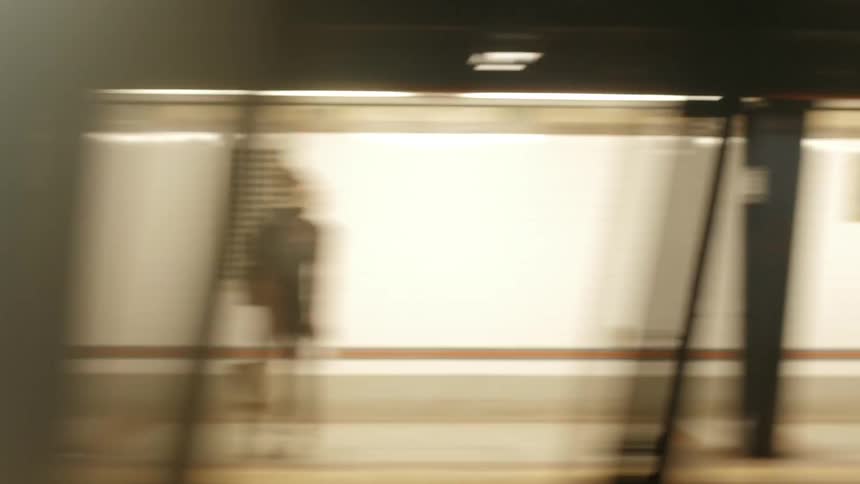View from inside of a commuter train as it speeds through a station