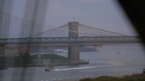Two bridges seen from a moving vehicle as it crosses another bridge