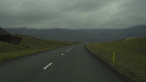 Driving down a cloudy road