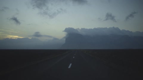 A vehicle drives on a rural road