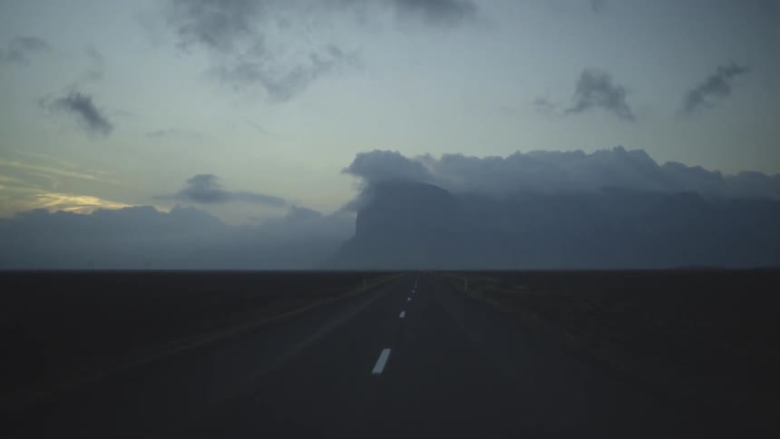 A vehicle drives on a rural road