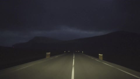 Driving fast down a road at night