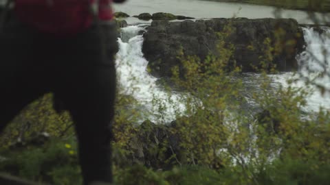 A person overlooking a waterfall
