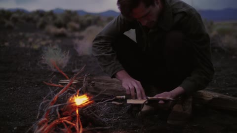 A person sitting by a campfire
