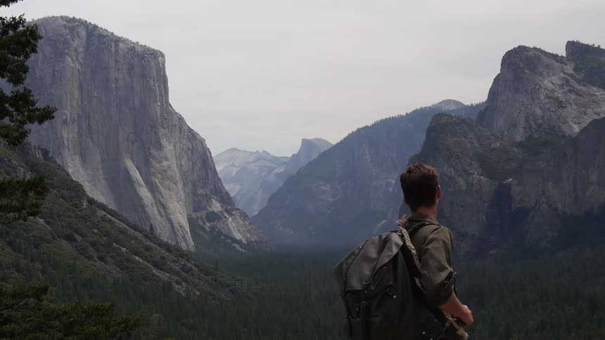 A man with a backpack hikes in the mountains