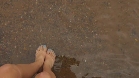 Female leg in a clear water