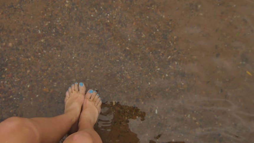 Female leg in a clear water