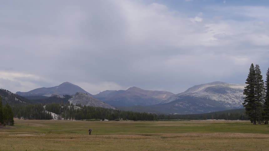 View of a green pasture in front of a mountainous region