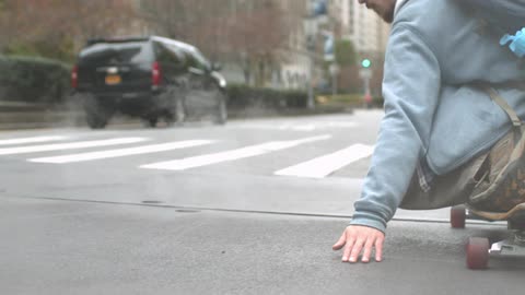 A man skateboarding in the city road