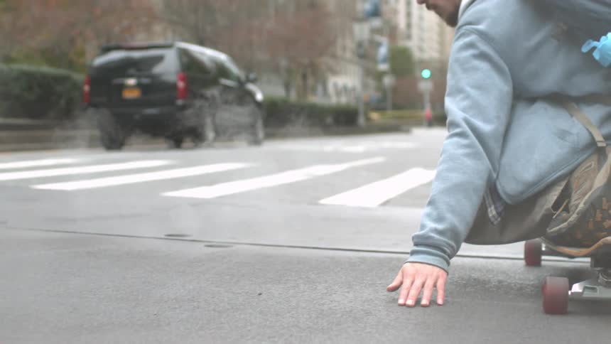 A man skateboarding in the city road