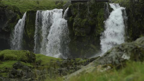 A waterfall cascades over a mountain