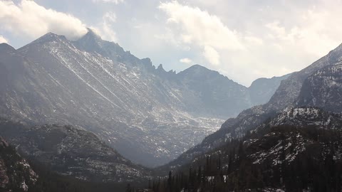 Mountains with clouds moving through them during the day