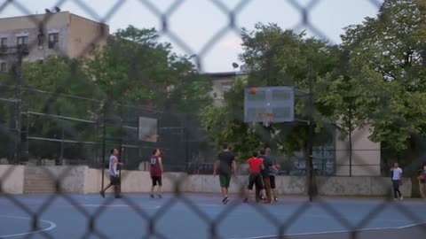 A pickup basketball game on an outdoor court