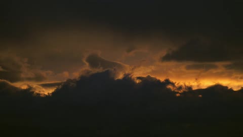 Clouds cover the sun as it sets