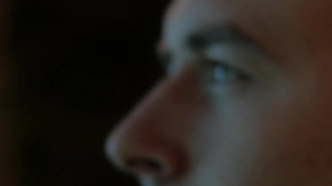 A reflection of screen light on man face