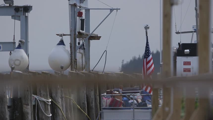 An american flag moves in the breeze on a boat